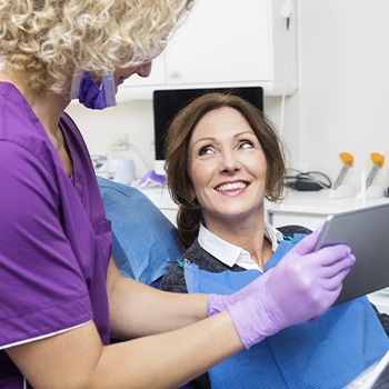 Patient smiling at dentist during dental treatment