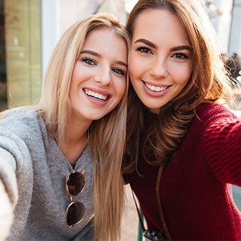 Two women smiling together after visiting the dentist