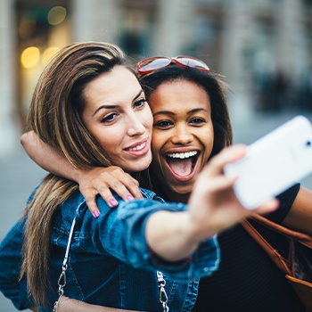 Two women smiling together after visiting the dentist