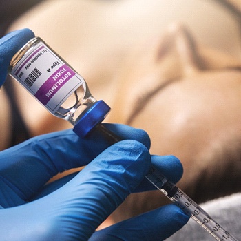 a dentist holding a vial of BOTOX