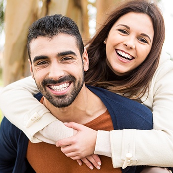 Man and woman with flawless smiles after cosmetic dentistry