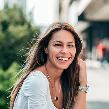 A portrait of a smiling young woman outdoors