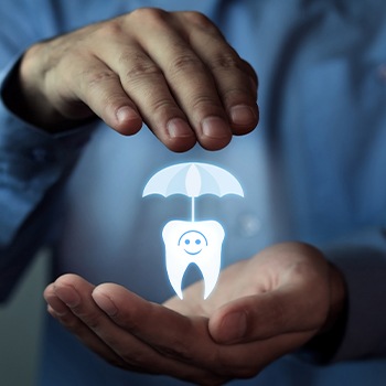 Hands holding an animated tooth under an umbrella