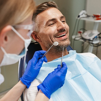 Man receiving dental checkup and teeth cleaning