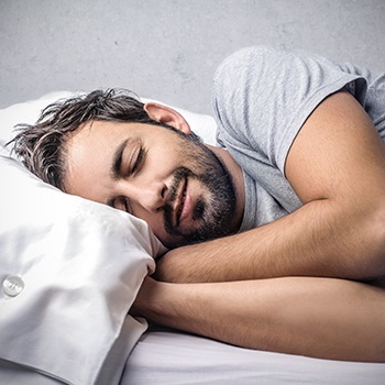 Man sleeping soundly thanks to sleep apnea therapy