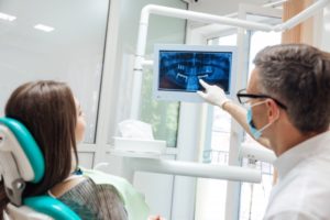 dentist showing patient dental x-rays