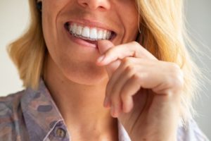 woman putting on Invisalign tray