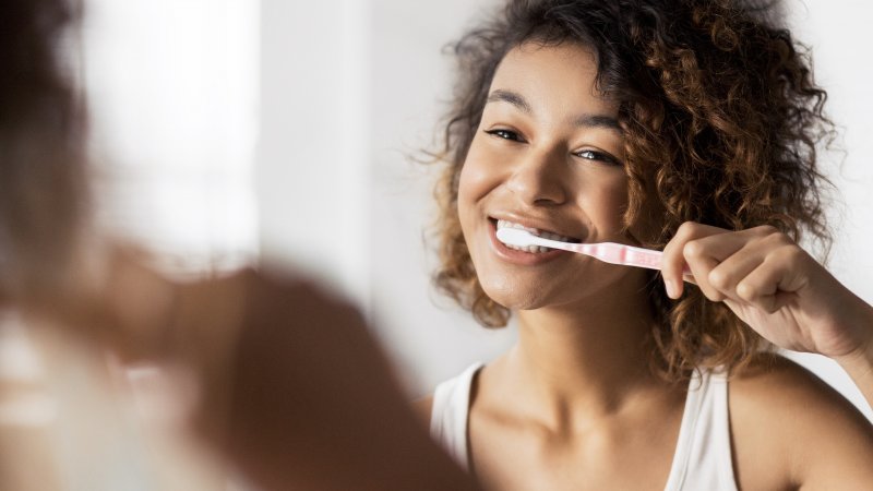 A woman  brushing her teeth