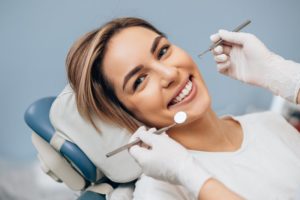 a woman smiling during her dental checkup